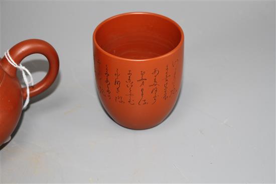 A Chinese Yixing teapot and cover, a redware teapot and cover and a cup